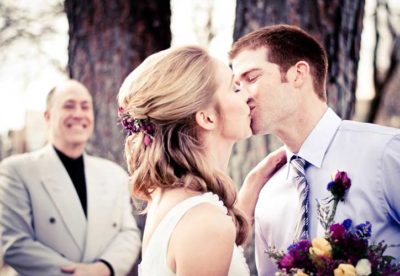 The bride and groom kiss